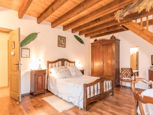 a bedroom with a bed and a wooden ceiling at Maison de village au calme avec grand verger - FR-1-583-446 in Francalmont