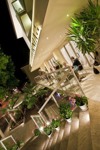 a room filled with lots of potted plants at California Pastry Hotel in Cervia