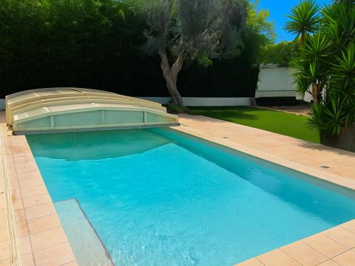 une piscine dans une cour avec une maison dans l'établissement Maison spacieuse avec piscine privée – Idéale pour familles - FR-1-732-109, à Latour-Bas-Elne