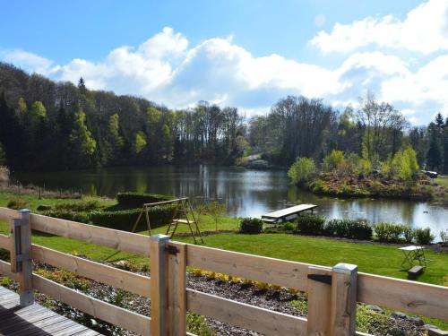 a view of a lake from a wooden fence at Gîte La Chapelle Pleine Nature, Animaux Bienvenus - FR-1-583-420 in La Rosière