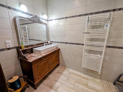 a bathroom with a sink and a mirror at Maison de caractère à Gy avec parking et Wifi - FR-1-583-448 in Gy