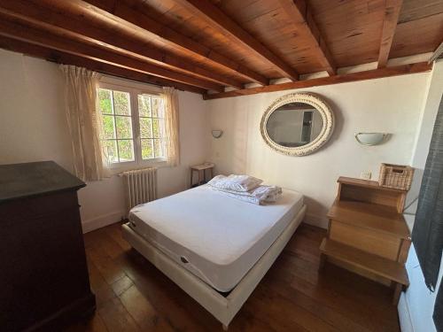 une chambre avec un lit blanc et un miroir dans l'établissement Charmante maison moderne avec terrasse et parking, cœur de Biarritz - FR-1-239-1132, à Biarritz