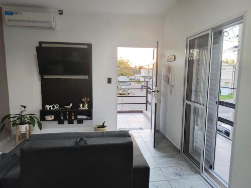 a living room with a couch and a sliding glass door at DS confort in General Pico