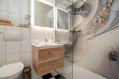ヴァーレンにあるApartment "Hafenkino" am Stadthafen Waren Müritzの洗面台とトイレ付きのバスルーム