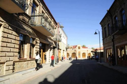 a group of people riding skateboards down a street at Daily rental house in Gori