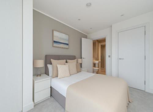 a white bedroom with a white bed and a door at Premium 2 Bed Flat near Colindale Station in Colindale
