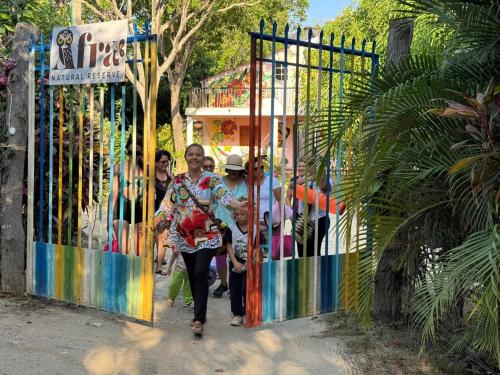 a group of people walking through a gate at AFRA Reserva Natural in Santa Marta