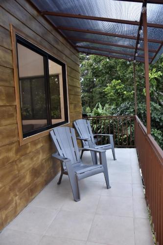 two chairs sitting on the porch of a house at Casa Jaspe Monteverde - Balcón vista en Monteverde in Monteverde Costa Rica