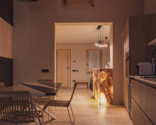 a kitchen and dining room with a table and chairs at Al Borgo 01 Luxury Suites in Sardinia in Abbasanta