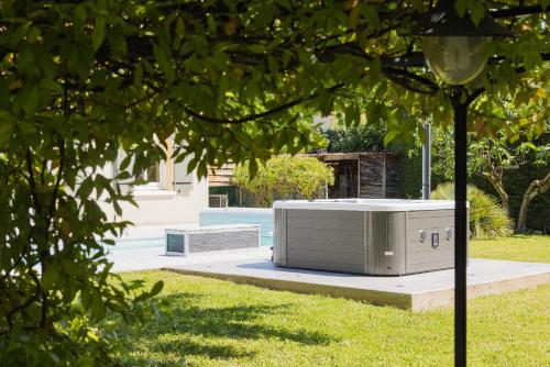 a metal object sitting on the grass in a yard at Villa avec Piscine, Jacuzzi et Sauna Privé dans les Dombes in Ambérieux-en-Dombes