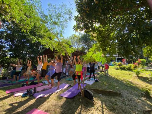 a group of people doing yoga in a park at AFRA Reserva Natural in Santa Marta