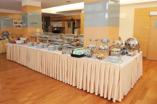 a long table with food on it in a room at Hotel Lovec in Bled