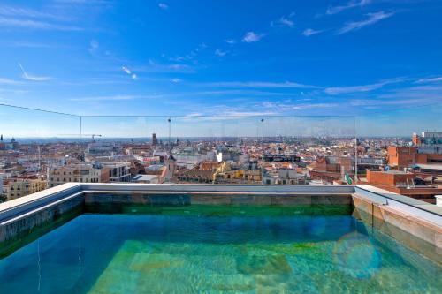 a swimming pool on top of a building at Pestana CR7 Gran Vía Madrid in Madrid