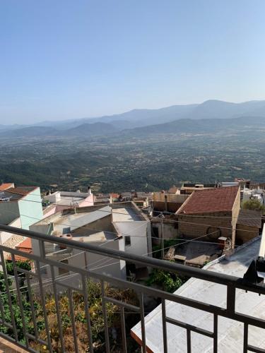 a view of a city from the balcony of a building at Dommu Montes e Mare in Baunei