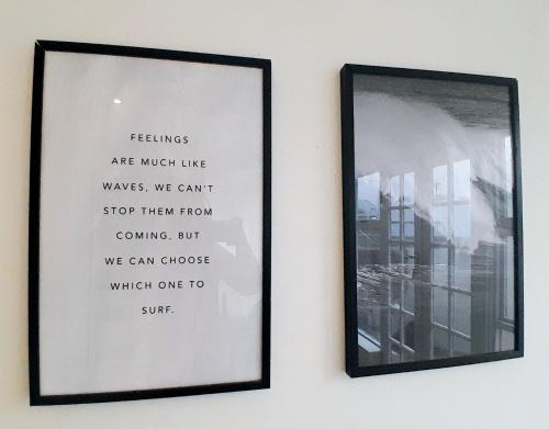 a framed picture on a wall next to a mirror at Mclaren Self Catering in Gansbaai