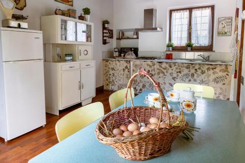 a kitchen with a table with eggs in a basket at Podere Pontassala in Palaia