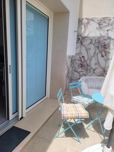 a living room with two chairs and a table at Cala Paradiso in Monopoli