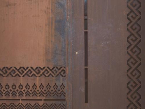 a wooden door with intricate patterns on it at Al Borgo 01 Luxury Suites in Sardinia in Abbasanta