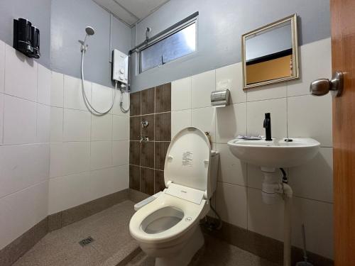 a bathroom with a toilet and a sink at The Borneo Homestay Cyber City Apartment in Donggongon