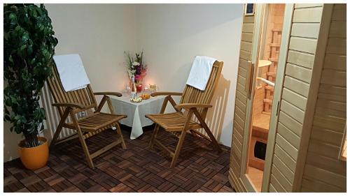 two chairs and a table in a room at ROMANTIK HOTEL ELEONORA in Tábor