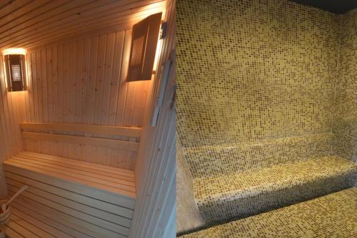 a bathroom with a sauna with a walk in shower at Villa Pirin in Simitli