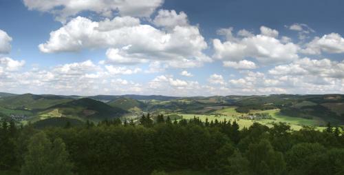 a view of a valley with trees and clouds at Landhotel Pingel in Sundern