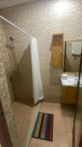 a bathroom with a shower and a sink at SKY HoTEL in Brazzaville