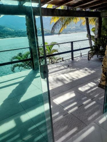a view of the ocean from a house balcony at Pousada Onda de Mar in Angra dos Reis
