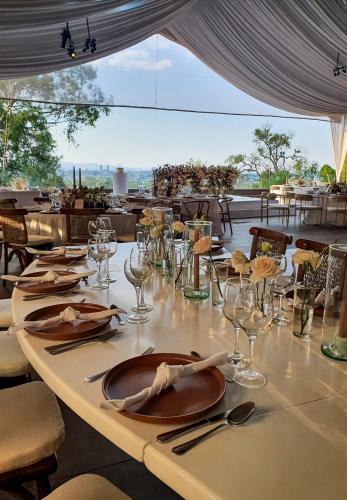 a table with wine glasses and plates on it at Villa Montaña Hotel & Spa in Morelia
