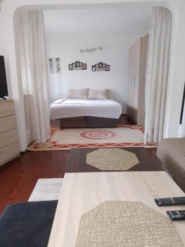 a bedroom with a bed and some rugs at Edinhome in Sarajevo