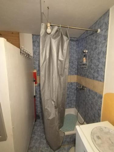 a shower with a shower curtain in a bathroom at Shambhala, eko selo Blatuša in Gvozd