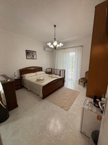 a bedroom with a bed and a chandelier at B&B Le Ninfee in Marina di Gioiosa Ionica