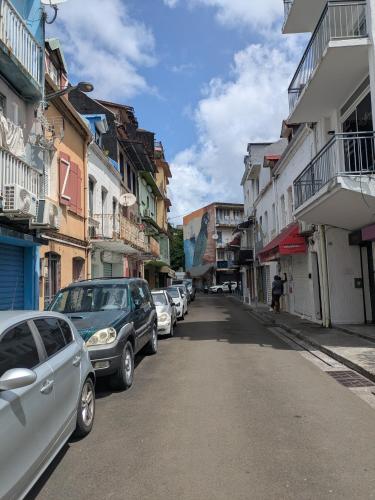 a street with cars parked on the side of the road at Small F2 in Fort-de-France in Fort-de-France