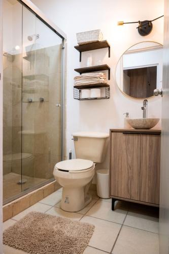 a bathroom with a toilet and a shower and a sink at Departamento Palo Verde in Hermosillo