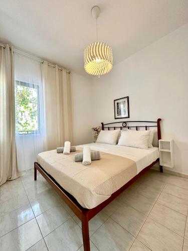 a bedroom with a large bed with a chandelier at Sea La Vie - Premium in Polychrono