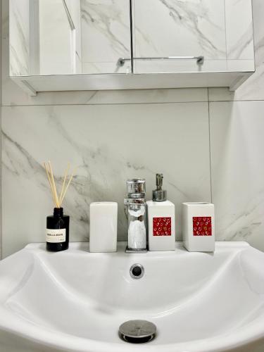 a white bathroom sink with candles and a mirror at Sea La Vie - Premium in Polychrono