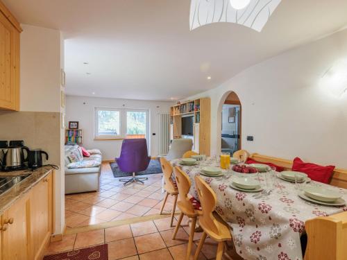 a kitchen and dining room with a table and chairs at Apartment Erika by Interhome in Canazei