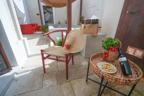 a chair and a table with a plate of food at B&B Le volte leccesi in Porto Cesareo