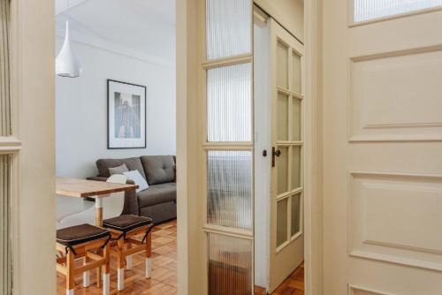 a door leading into a living room with a table at Cozy 1-Bedroom with Private Terrace in Palmela in Porto