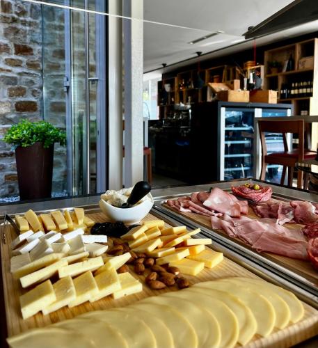 a display of cheese and meats on a counter at VENEZIANA Boutique Hotel Superior in Koper
