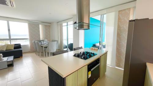 a kitchen and living room with a stove top oven at Magico PentHouse Duplex Frente al Mar 3 Habs FB112 in Coveñas