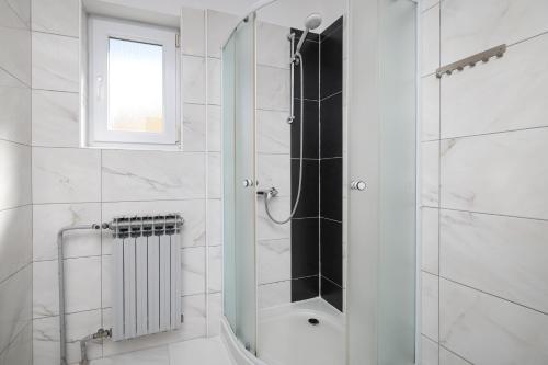 a shower with a glass door in a bathroom at Villa Anton in Sukošan