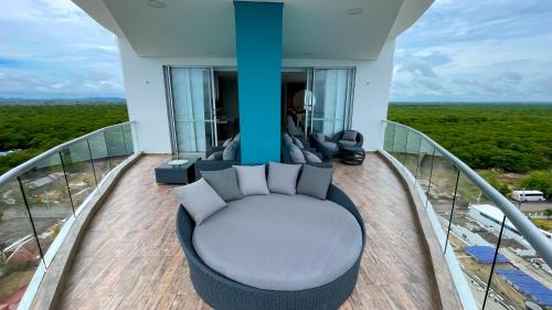 a balcony of a house with a couch at Magico PentHouse Duplex Frente al Mar 3 Habs FB112 in Coveñas