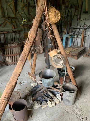 a group of pots and pans on top of a fire at Tra Fiori e Antichità in Cerchiara