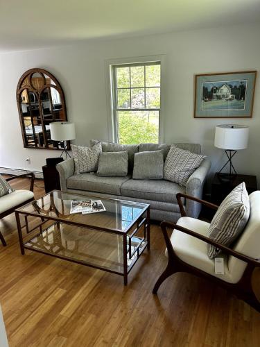 a living room with a couch and a coffee table at House Conveniently Located by Route 1 in Falmouth