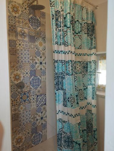 a bathroom with a shower with a shower curtain at Casa Sole Luna in Torre del Greco