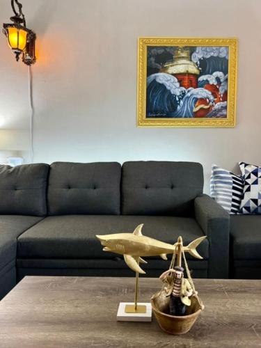 a living room with a couch and a shark statue on a table at Comfy, Close to Downtown with Lake & Lift Bridge Views in Duluth