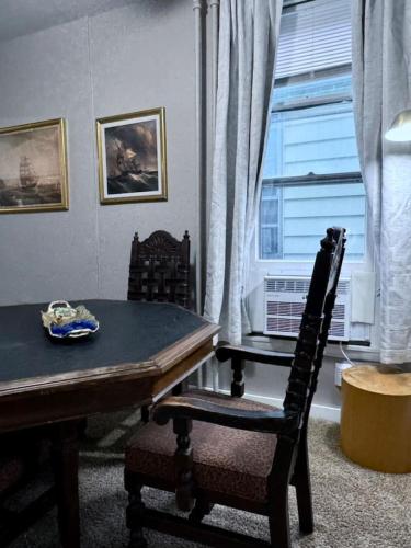a dining room with a table and chairs and a window at Comfy, Close to Downtown with Lake & Lift Bridge Views in Duluth