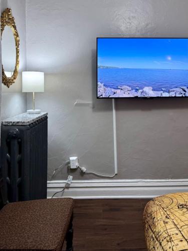 a room with a flat screen tv on a wall at Comfy, Close to Downtown with Lake & Lift Bridge Views in Duluth