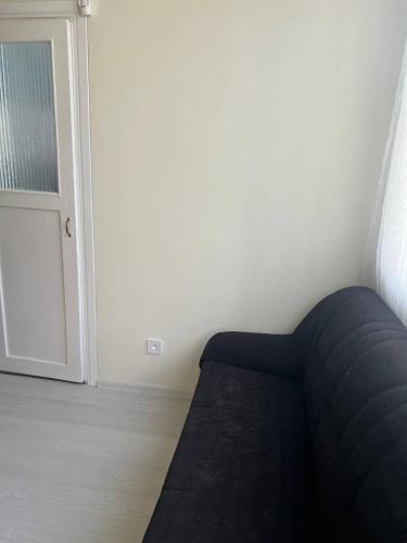 a blue couch in a room with a door at Vienibas prospekts in Jūrmala